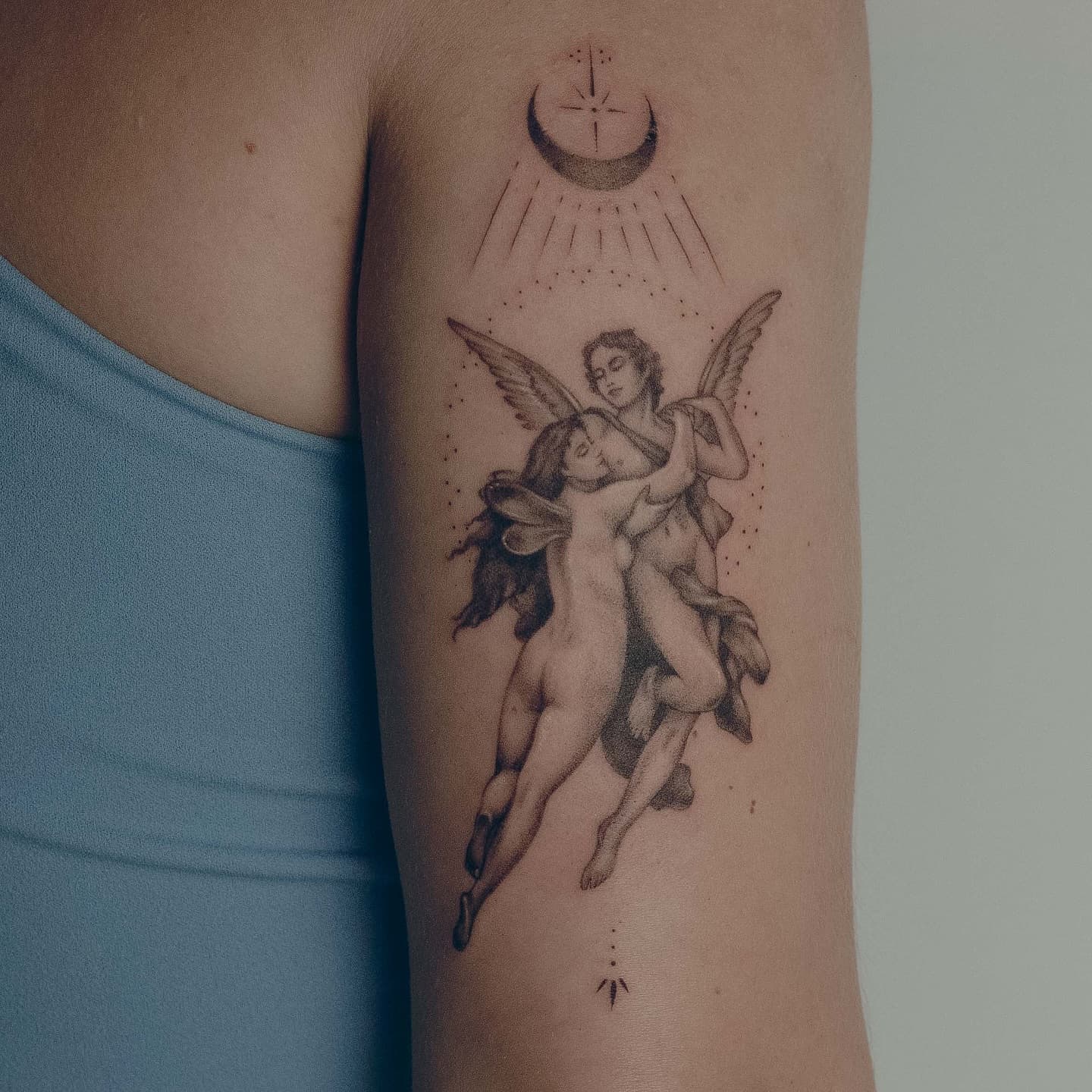 Amor i Psyche według rzeźby, z księżycem, na ramieniu – tatuaż fine line
